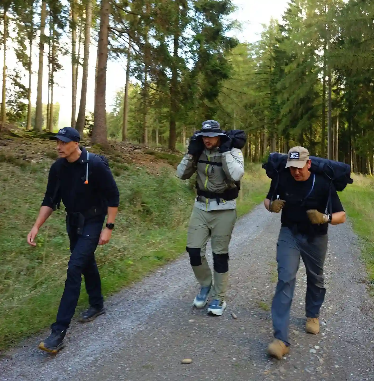 Image: Team mates carrying the sandbags.