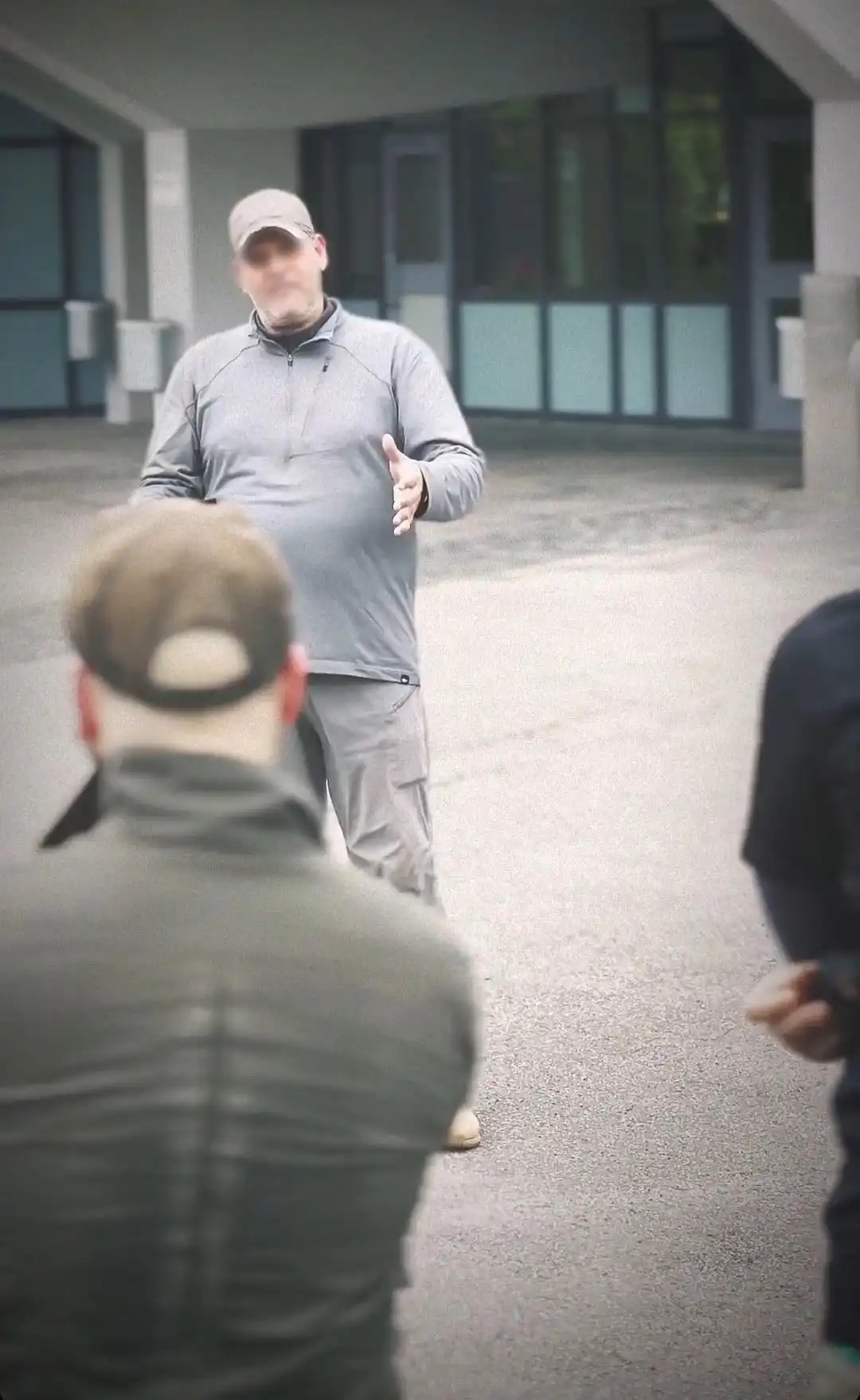 Image: Participant sharing a story about Milton in front of the high school he went to