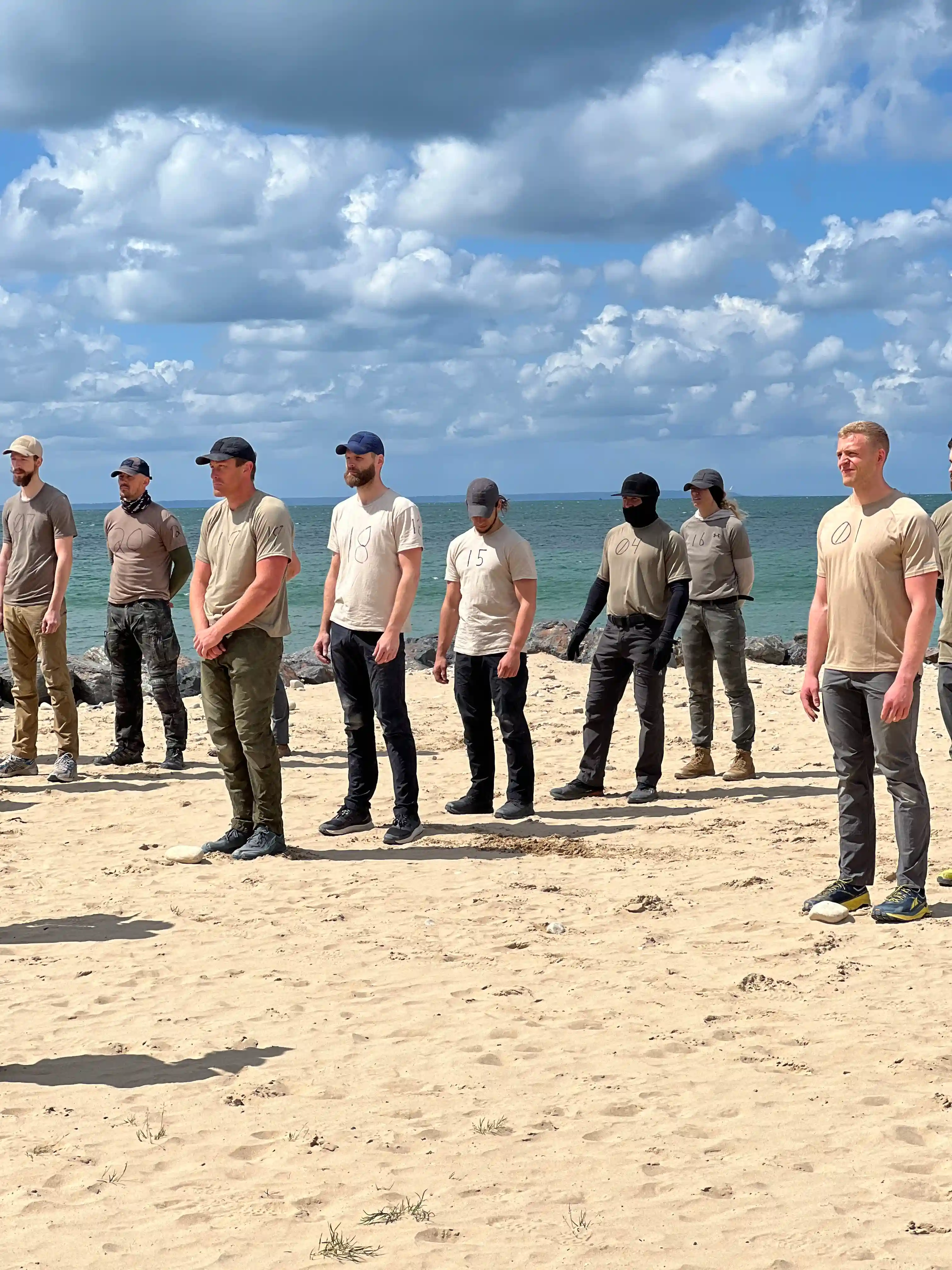 Image: Candidates getting instructions how to perform the sandbag burpees